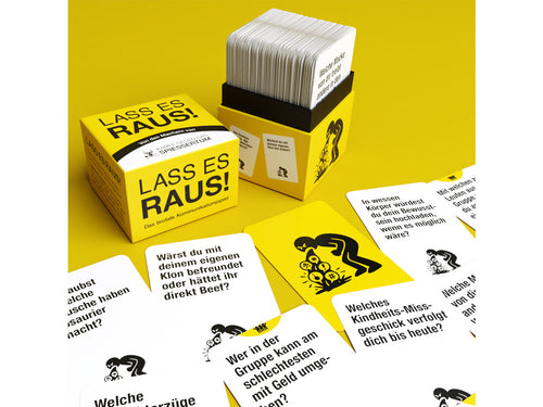 Lass es raus!: Box mit ausgelegten Fragekarten in Gelb und Weiß.